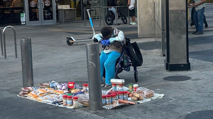 Helping hand for an old grandma who’s selling food outside campaign photo, 1 of 3